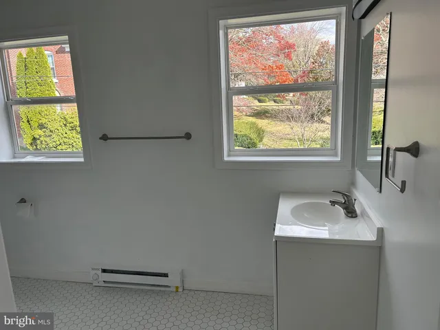 a bathroom with a sink and a window