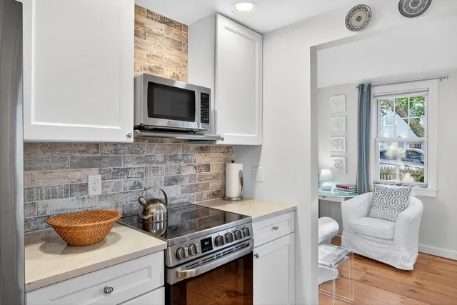 a kitchen with stainless steel appliances a stove a microwave and cabinets