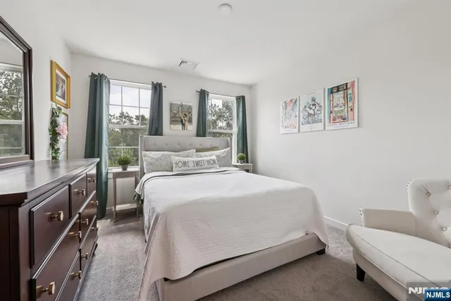 a bedroom with a bed and a couch