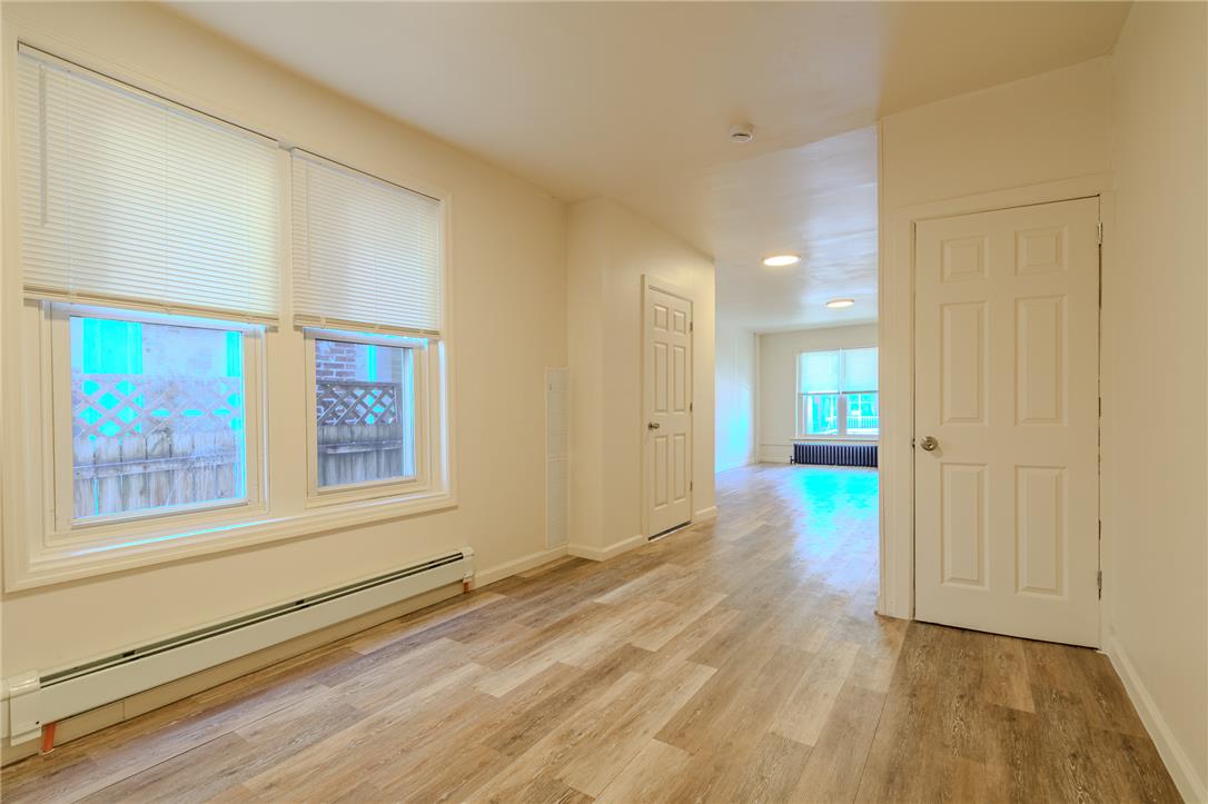 820 North 5th Street Allentown, PA 18102 - Photo 21 of 39 Clean hardwood-style flooring extends through this open concept living area, bathed in natural light.