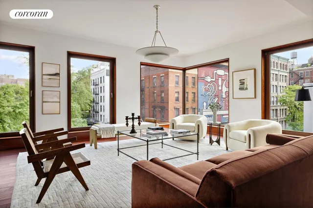 a living room with furniture and floor to ceiling windows