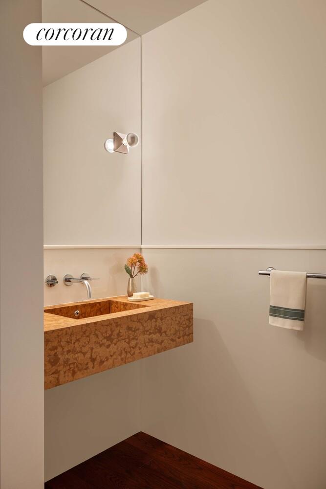 83 Thompson Street, Unit 5 Manhattan, NY 10012 - Photo 15 of 31 a bathroom with a sink and a mirror