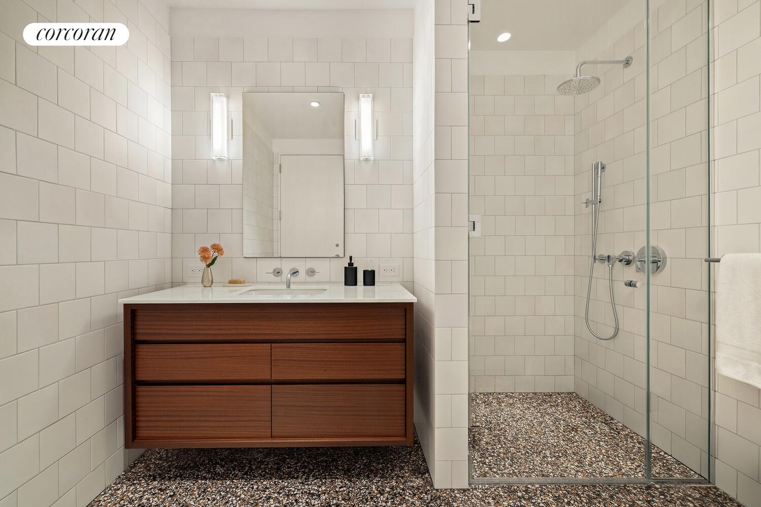 83 Thompson Street, Unit 5 Manhattan, NY 10012 - Photo 20 of 31 a bathroom with a sink a mirror and shower