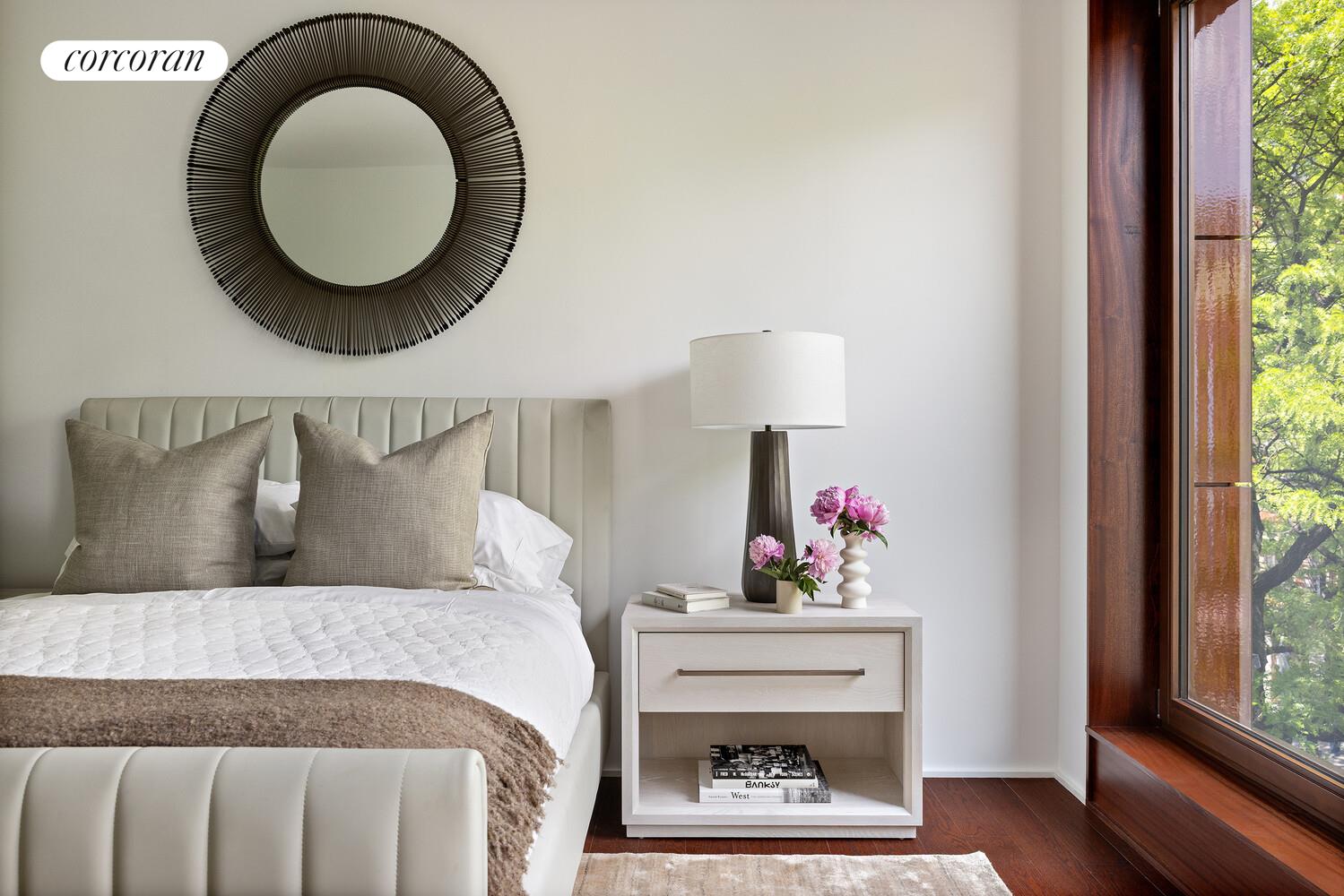 83 Thompson Street, Unit 5 Manhattan, NY 10012 - Photo 21 of 31 a bed room with a bed mirror and a window