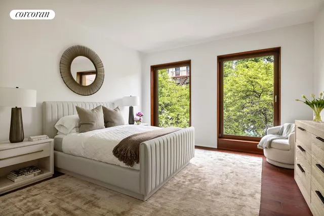 a bedroom with a bed and a potted plant