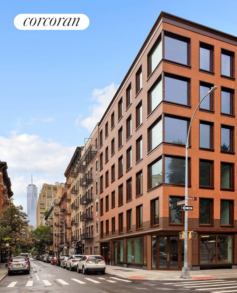 83 Thompson Street, Unit 5 Manhattan, NY 10012 - Photo 27 of 31 a front view of a building with lot of cars and trees