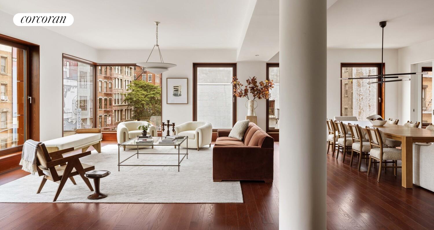 83 Thompson Street, Unit 5 Manhattan, NY 10012 - Photo 2 of 31 a living room with fireplace furniture and a large window