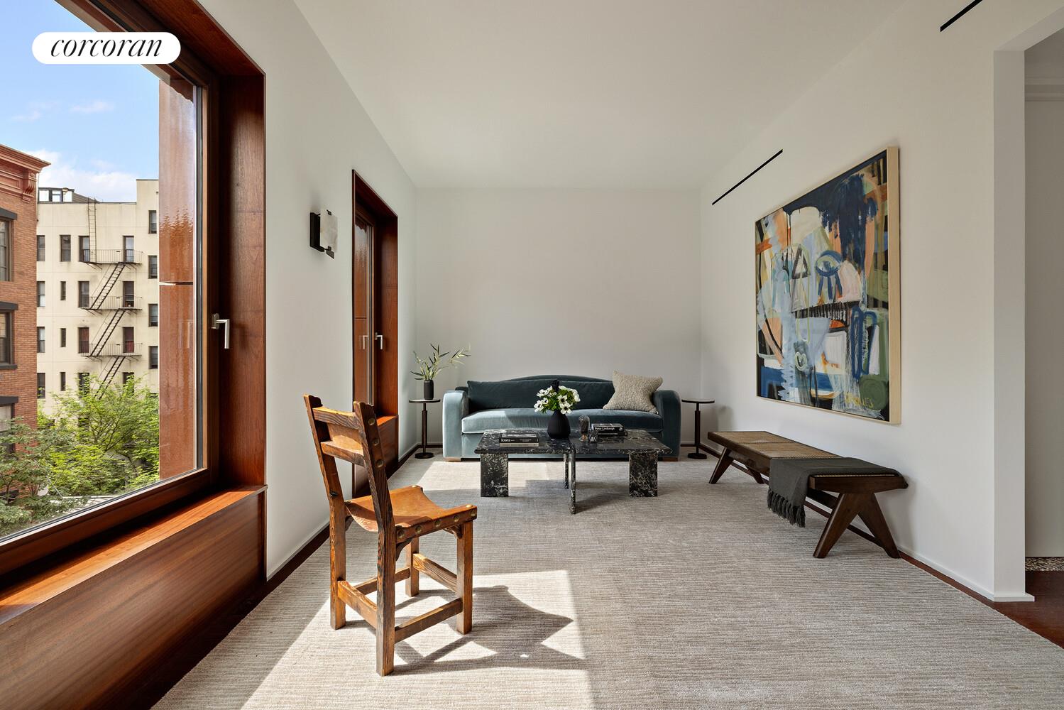 83 Thompson Street, Unit 5 Manhattan, NY 10012 - Photo 7 of 31 a living room with furniture and a large window