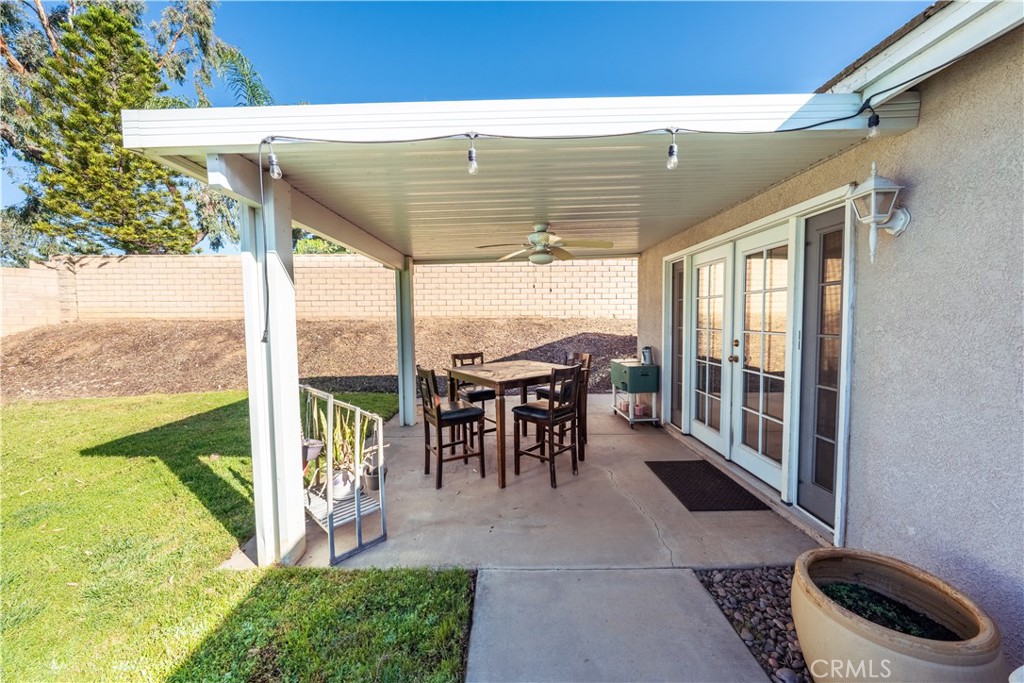 10451 Morning Ridge Drive Moreno Valley, CA 92557 - Photo 16 of 56 a view of a patio with table and chairs and potted plants