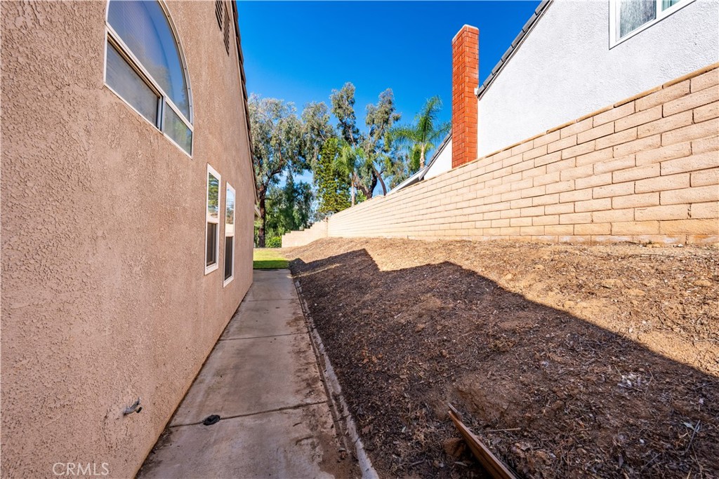 10451 Morning Ridge Drive Moreno Valley, CA 92557 - Photo 17 of 56 a view of a pathway along the building