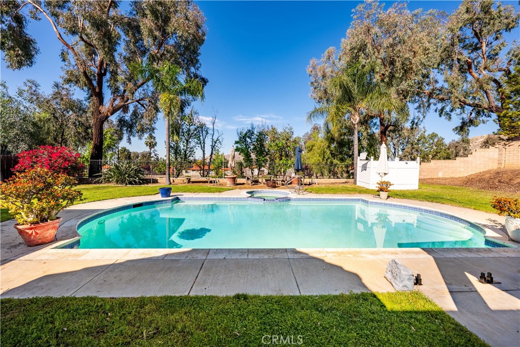 10451 Morning Ridge Drive Moreno Valley, CA 92557 - Photo 18 of 56 a view of a swimming pool with an outdoor space
