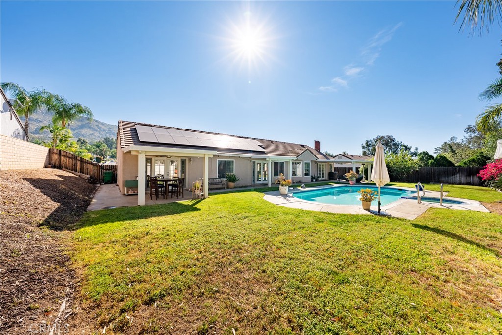 10451 Morning Ridge Drive Moreno Valley, CA 92557 - Photo 19 of 56 a view of a swimming pool with a garden and plants