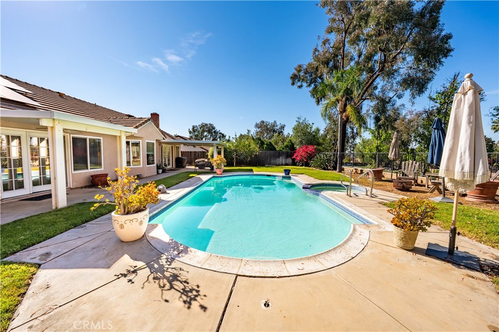 10451 Morning Ridge Drive Moreno Valley, CA 92557 - Photo 20 of 56 a view of a swimming pool with a patio