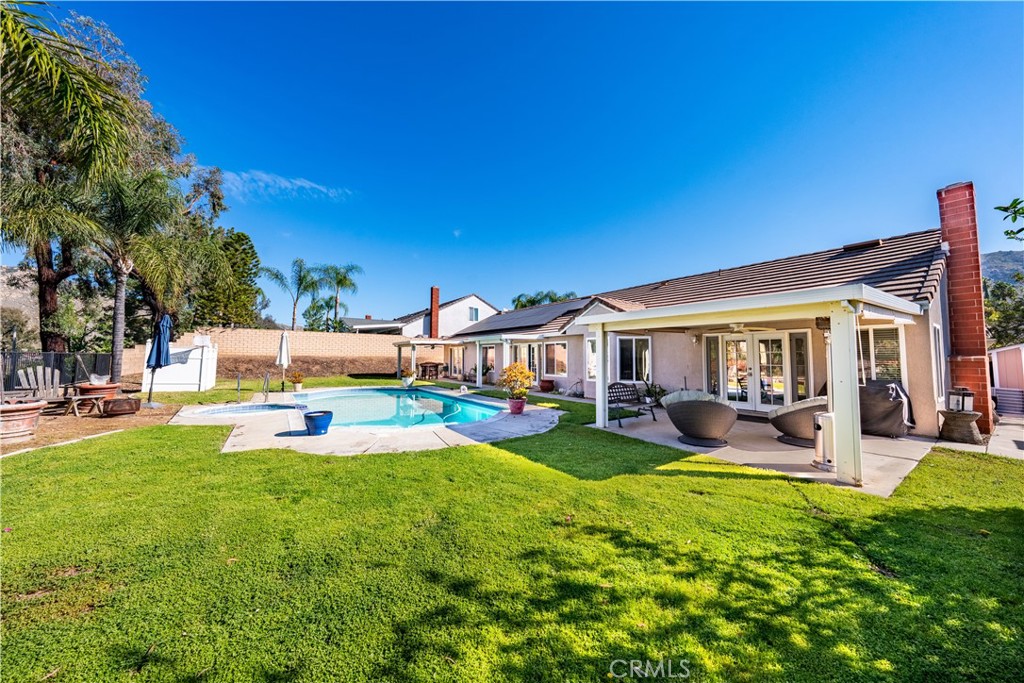 10451 Morning Ridge Drive Moreno Valley, CA 92557 - Photo 23 of 56 a view of a house with swimming pool and sitting area