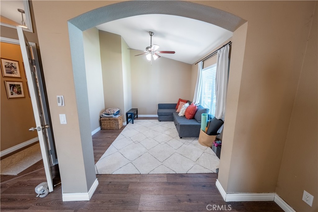 10451 Morning Ridge Drive Moreno Valley, CA 92557 - Photo 27 of 56 a living room with furniture and a chandelier