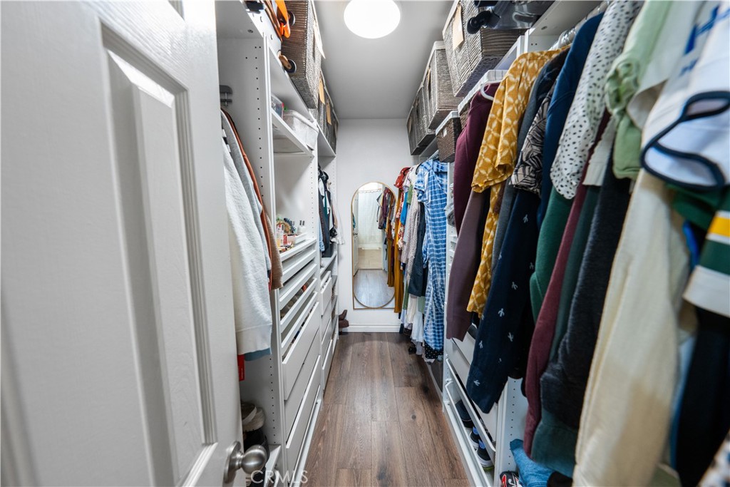 10451 Morning Ridge Drive Moreno Valley, CA 92557 - Photo 30 of 56 a view of walk in closet with clothes and shoes