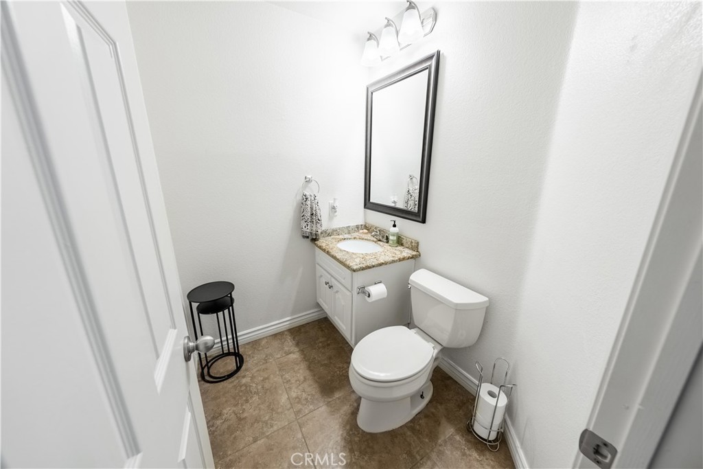 10451 Morning Ridge Drive Moreno Valley, CA 92557 - Photo 34 of 56 a white toilet sitting next to a sink