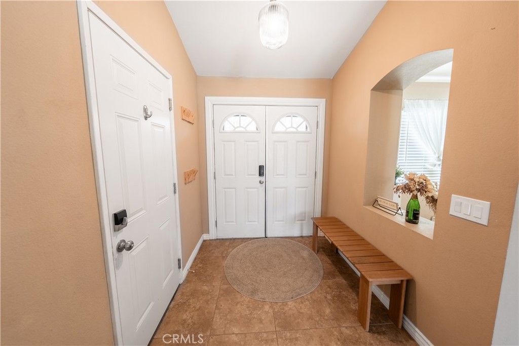 10451 Morning Ridge Drive Moreno Valley, CA 92557 - Photo 35 of 56 a spacious bathroom with a granite countertop sink a mirror and a shower