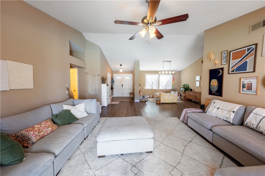 10451 Morning Ridge Drive Moreno Valley, CA 92557 - Photo 38 of 56 a living room with furniture and a chandelier
