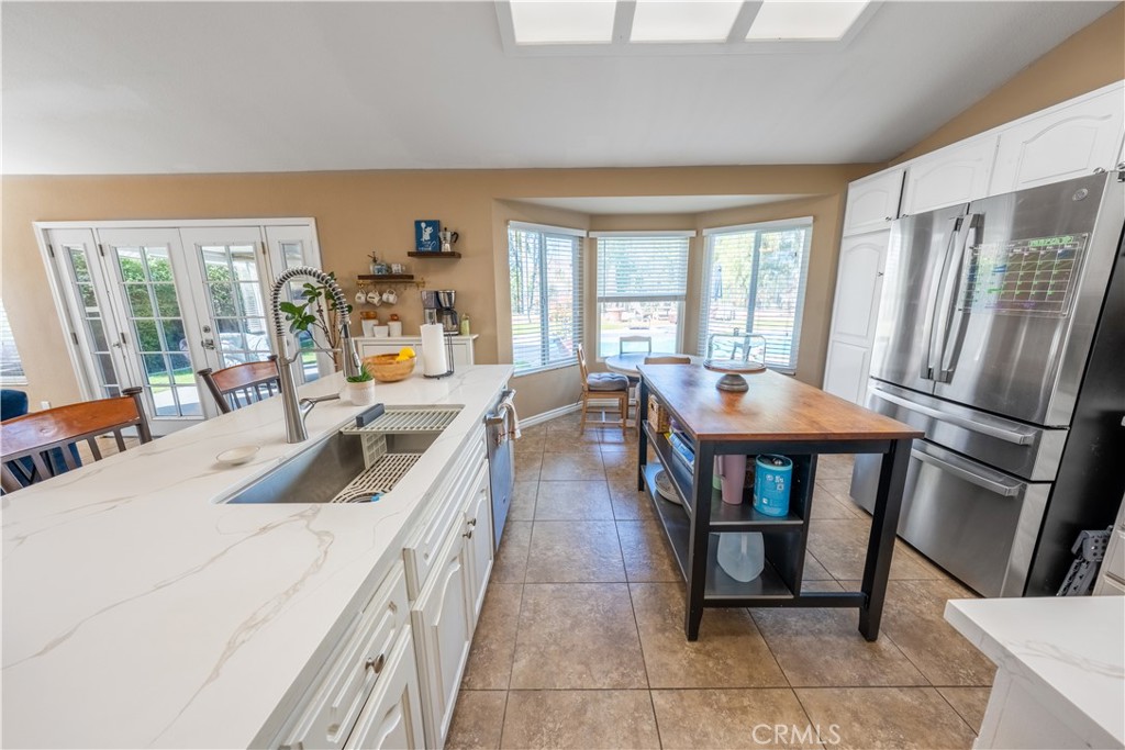 10451 Morning Ridge Drive Moreno Valley, CA 92557 - Photo 42 of 56 a view of a dining room with furniture large windows and wooden floor