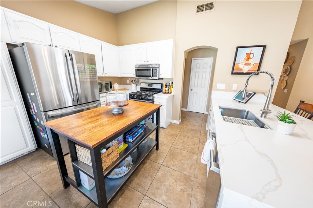 10451 Morning Ridge Drive Moreno Valley, CA 92557 - Photo 44 of 56 a room with furniture and a refrigerator