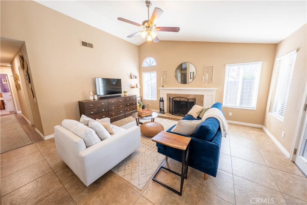 10451 Morning Ridge Drive Moreno Valley, CA 92557 - Photo 46 of 56 a living room with furniture a fireplace and a flat screen tv