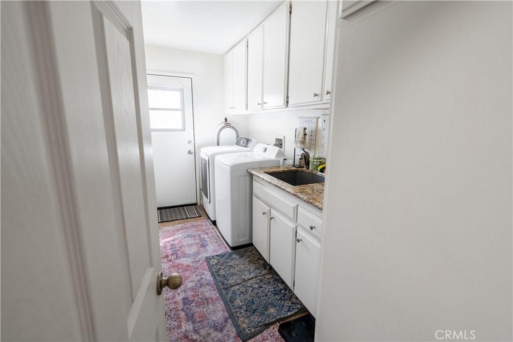 10451 Morning Ridge Drive Moreno Valley, CA 92557 - Photo 50 of 56 a kitchen with white cabinets sink and stove