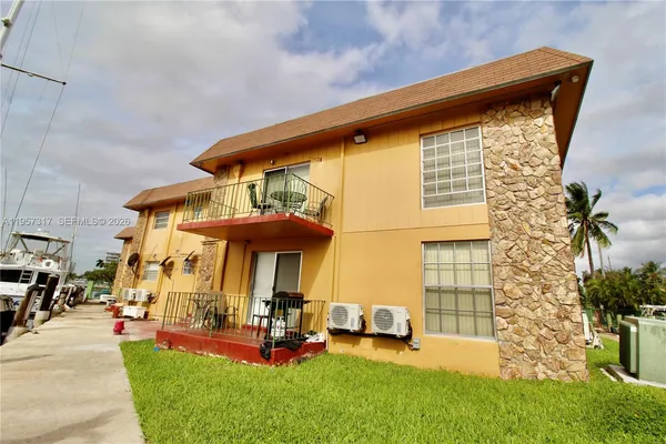 a view of a patio with table and chairs under an umbrella
