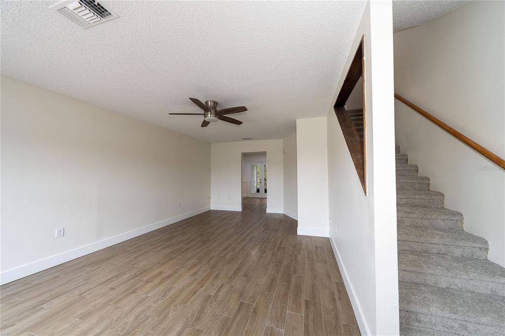 8557 Pilgrim Court New Port Richey, FL 34653 - Photo 16 of 29 a view of a hallway with wooden floor and staircase