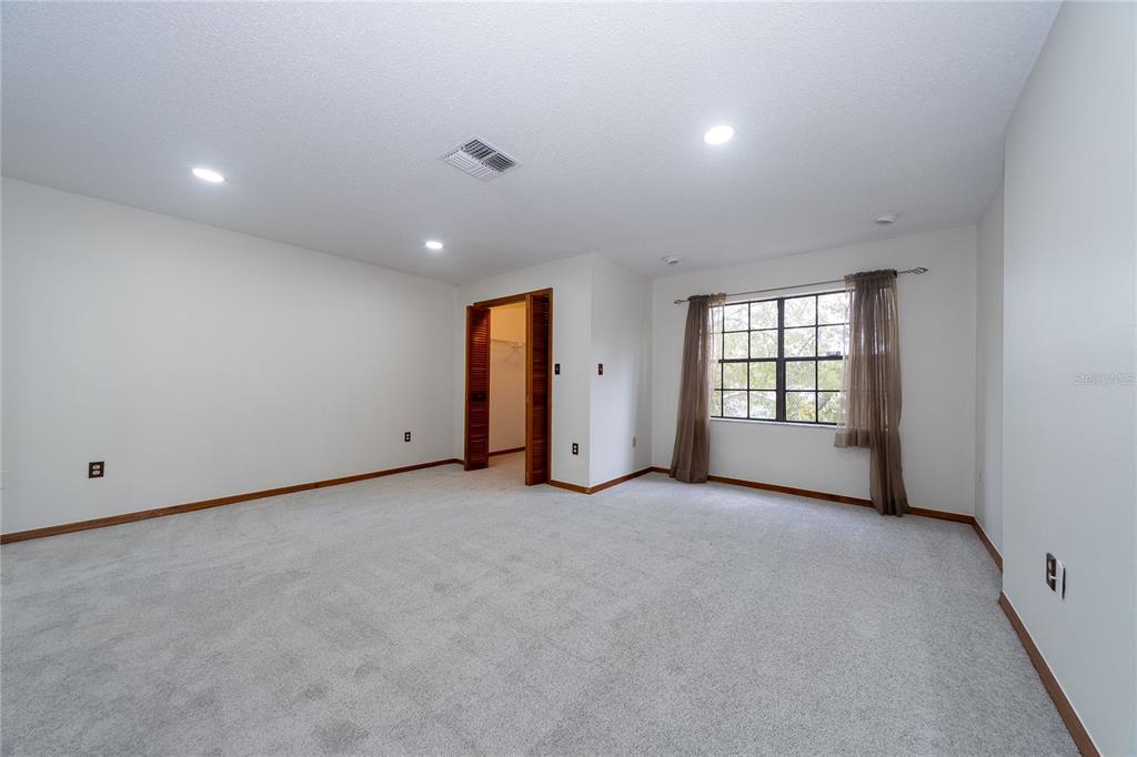 8557 Pilgrim Court New Port Richey, FL 34653 - Photo 25 of 29 an empty room with windows