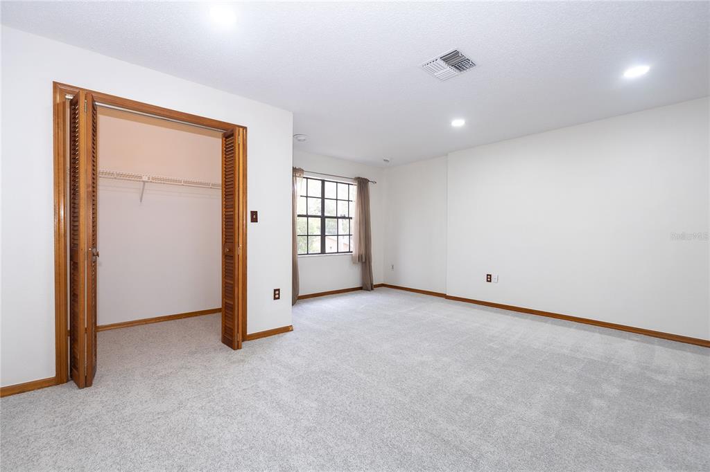 8557 Pilgrim Court New Port Richey, FL 34653 - Photo 27 of 29 an empty room with windows and closet
