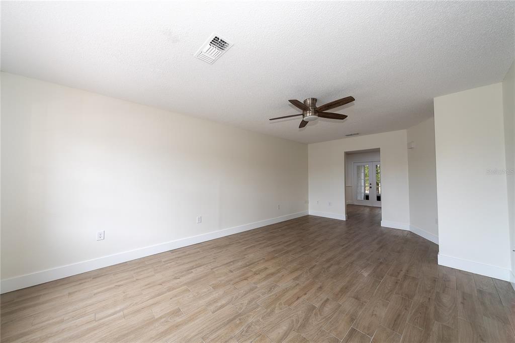 8557 Pilgrim Court New Port Richey, FL 34653 - Photo 7 of 29 a view of an empty room with a ceiling fan