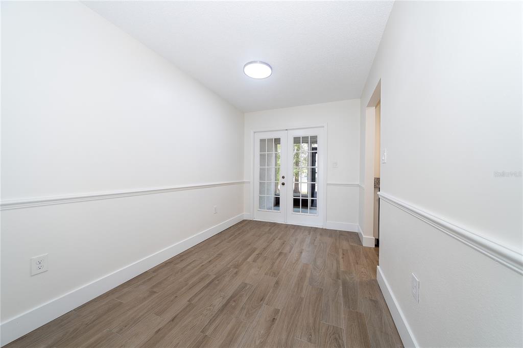 8557 Pilgrim Court New Port Richey, FL 34653 - Photo 8 of 29 a view of a room with wooden floor