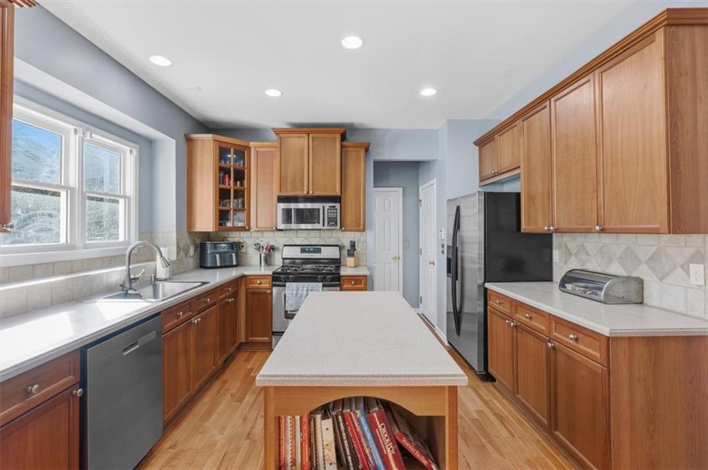 175 Gellmore Lane Acworth, GA 30101 - Photo 14 of 67 a view of a kitchen with kitchen island a sink a stove a refrigerator cabinets and a window