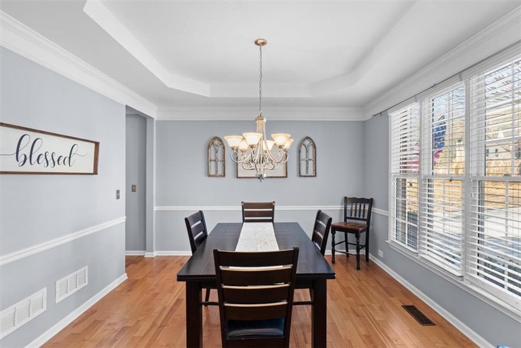 175 Gellmore Lane Acworth, GA 30101 - Photo 22 of 67 a dining room with furniture a chandelier and wooden floor