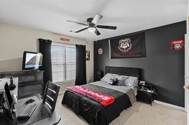 an empty room with a ceiling fan and a window