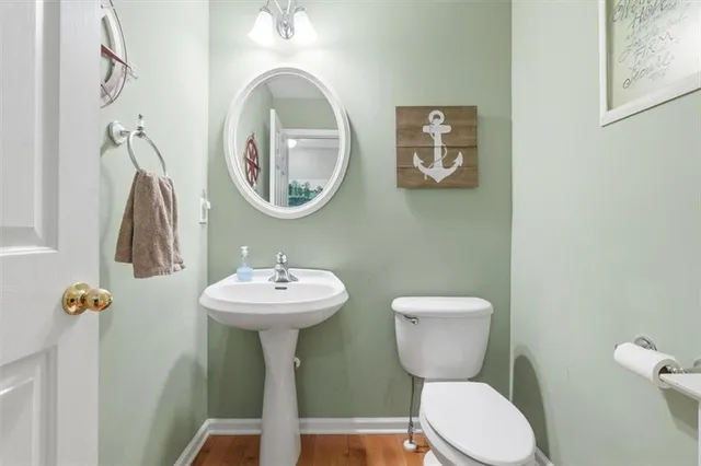 a white toilet sitting next to a bathroom sink