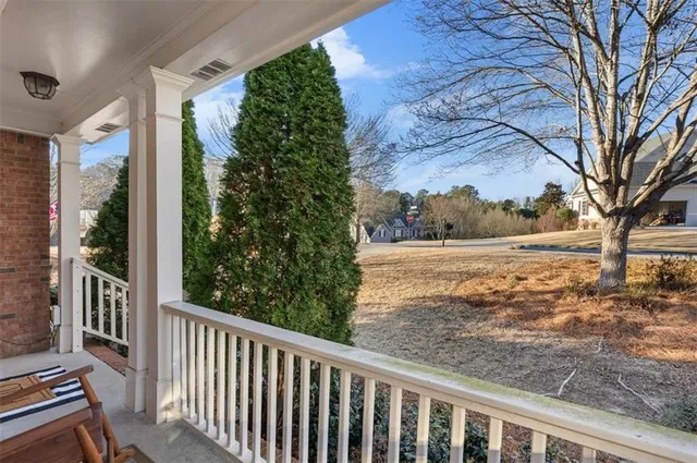 a view of a yard with wooden fence