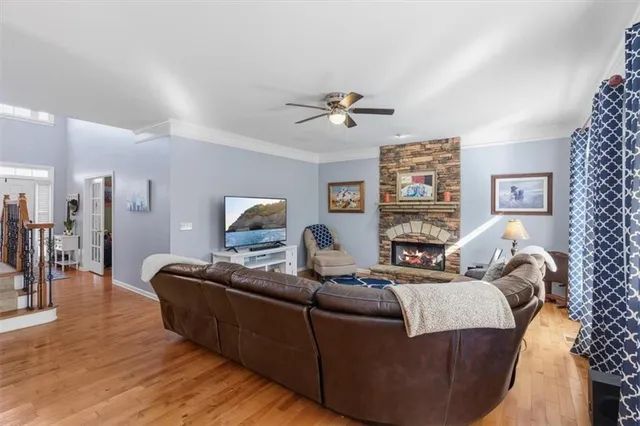 a view of a kitchen with kitchen island a sink a stove a refrigerator cabinets and a window