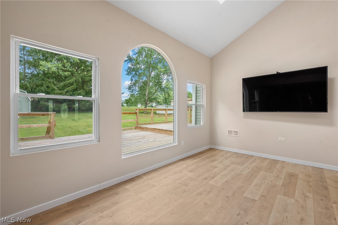 1617 Graham Road Stow, OH 44224 - Photo 12 of 49 Empty room with plenty of natural light, light wood-type flooring, and lofted ceiling