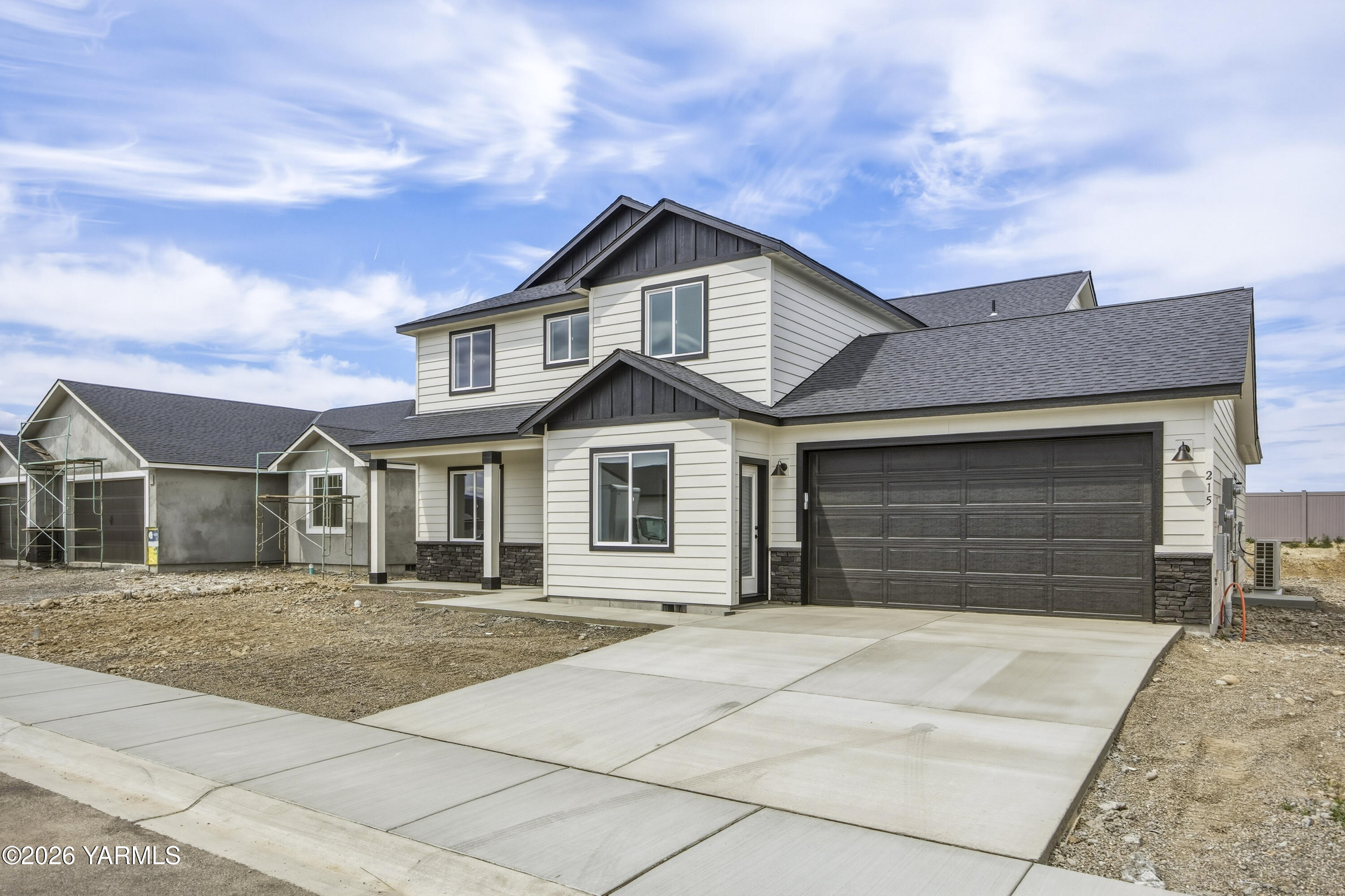 215 Packer Street Prosser, WA 99350 - Photo 40 of 45 a front view of a house with a yard and garage