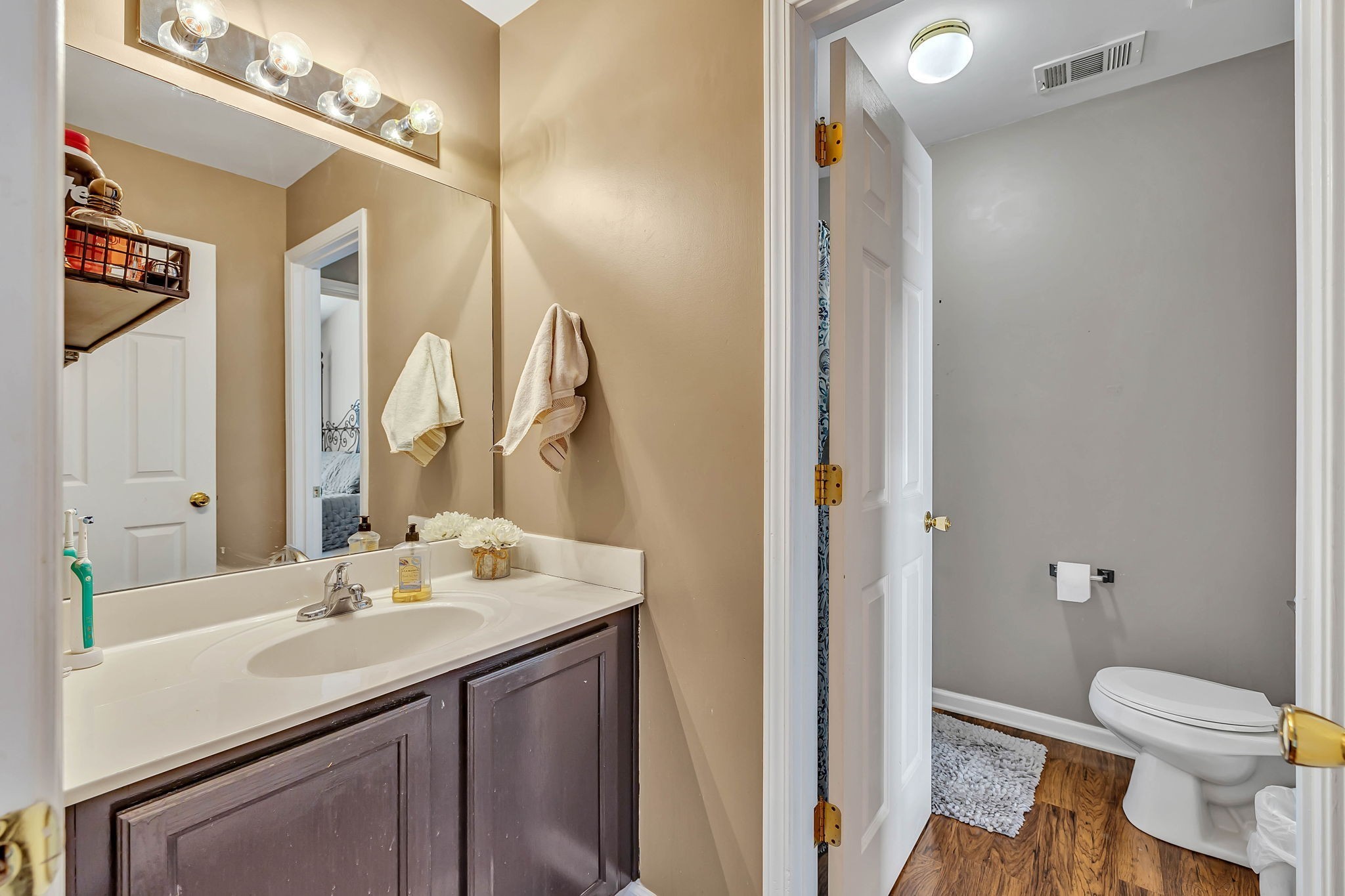 1101 Downs Boulevard, Unit I104 Franklin, TN 37064 - Photo 17 of 22 a bathroom with a sink vanity mirror and toilet