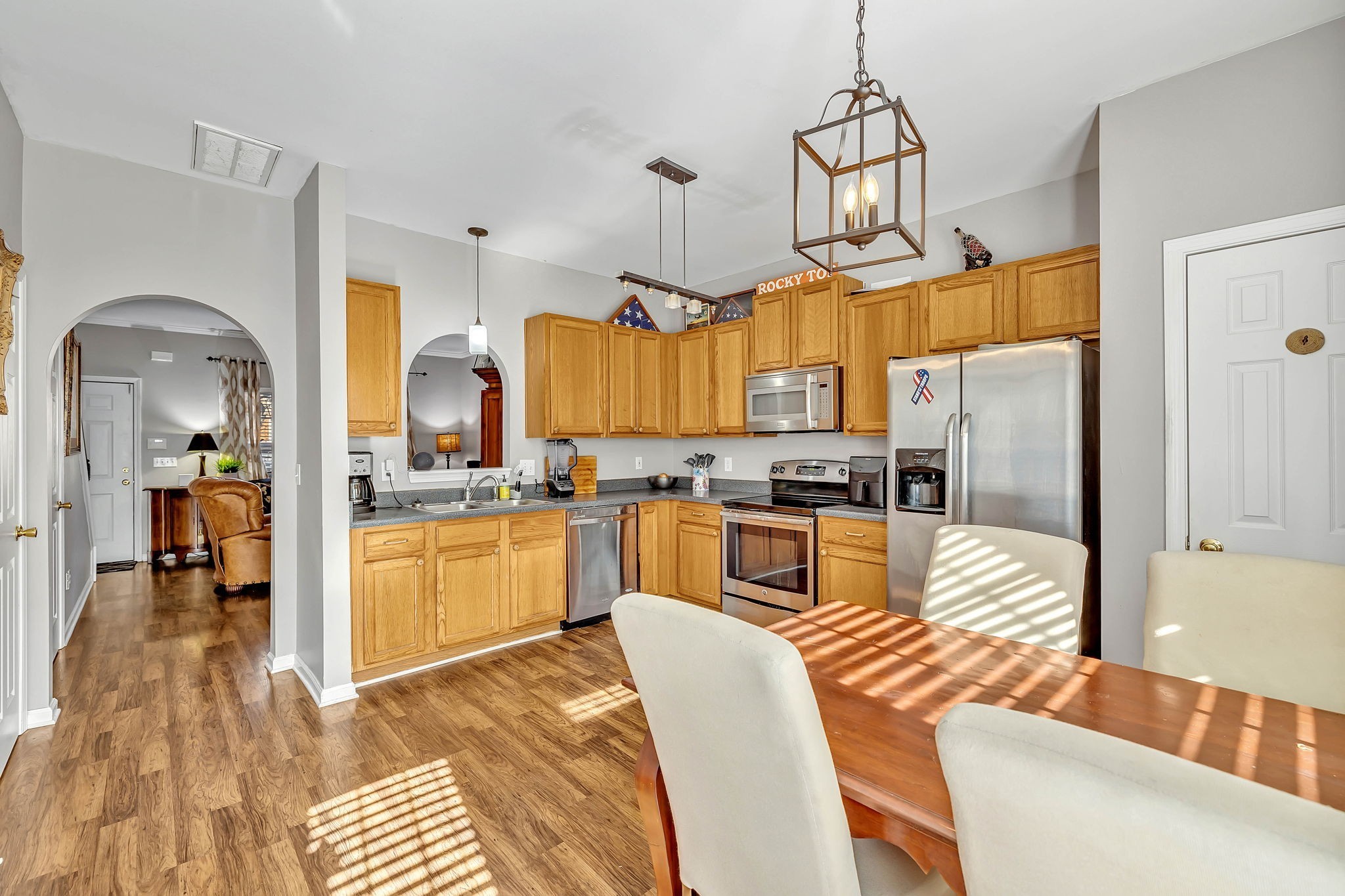 1101 Downs Boulevard, Unit I104 Franklin, TN 37064 - Photo 5 of 22 a kitchen with stainless steel appliances granite countertop a refrigerator and microwave