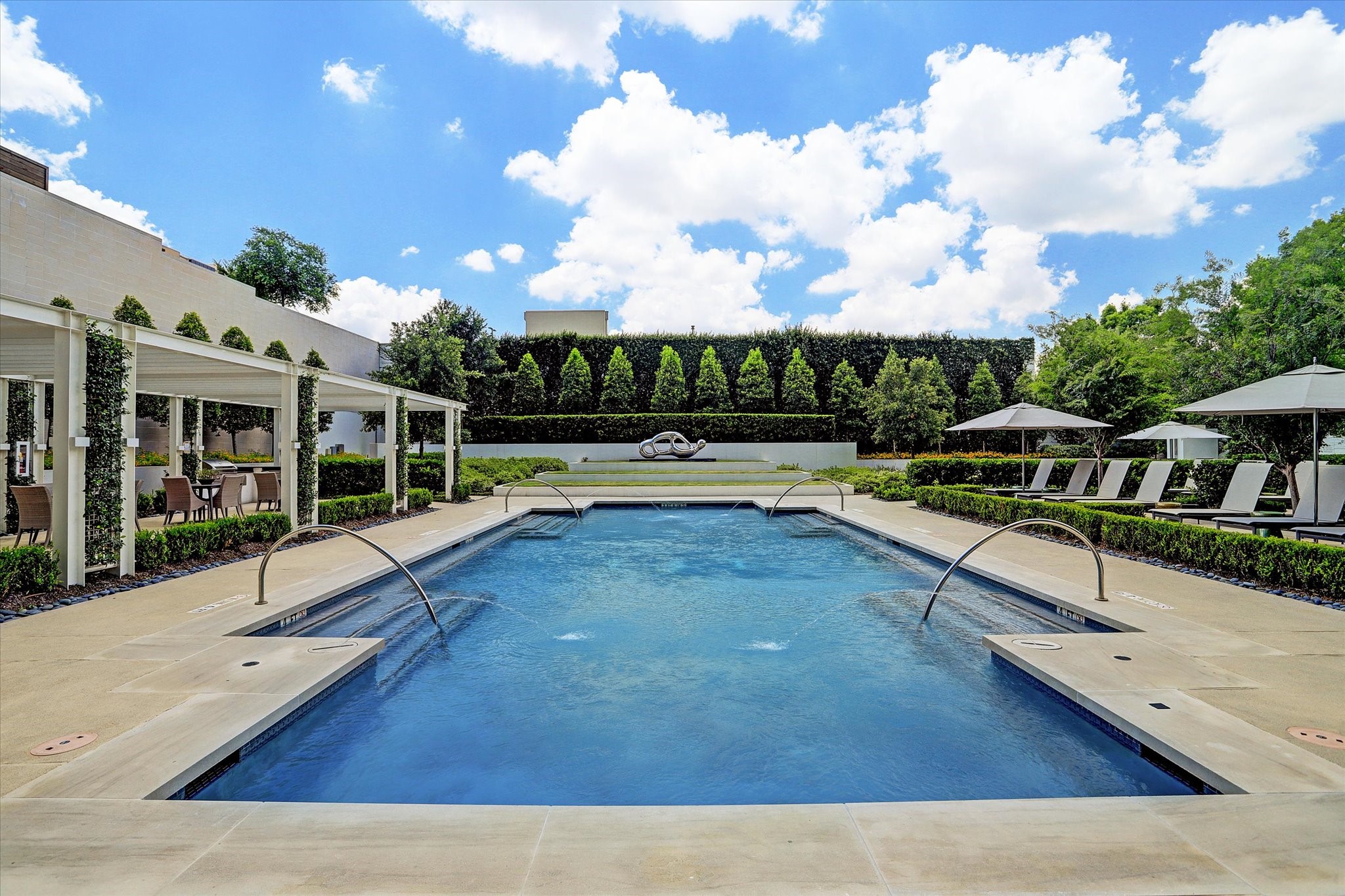 3433 Westheimer Road, Unit 702 Houston, TX 77027 - Photo 36 of 48 Resort-inspired pool surrounded by lush landscaping, cabanas, and inviting spaces to unwind year-round.