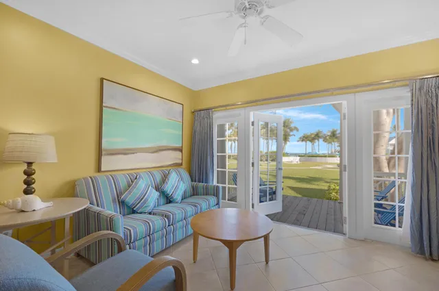 a living room with furniture floor to ceiling window and a floor to ceiling window