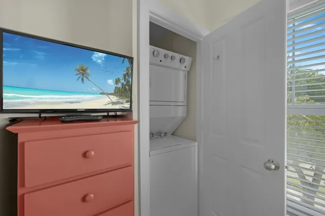 a bedroom with two beds and a large window