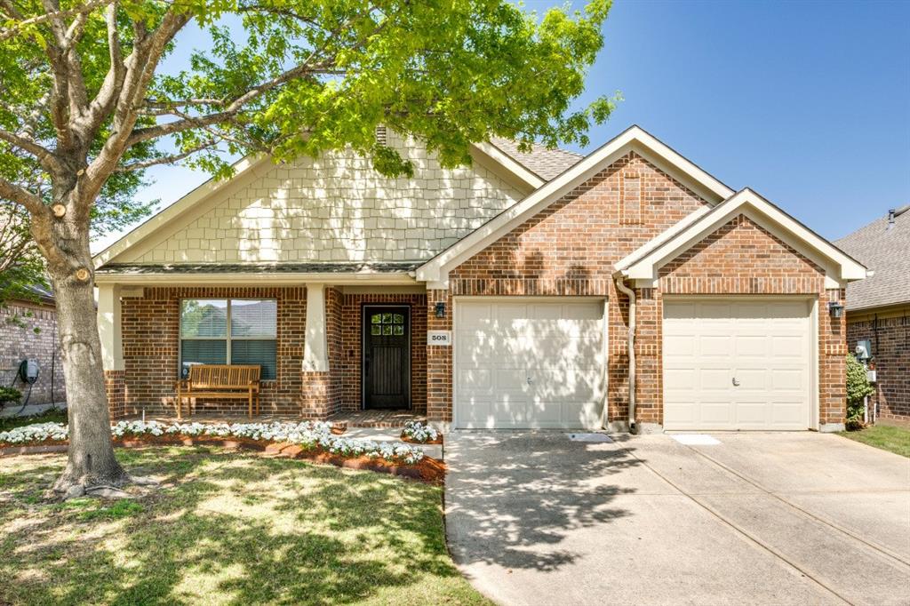 508 Hackberry Drive Fate, TX 75087 - Photo 1 of 1 View of front of home featuring a garage, concrete driveway, brick siding, and a porch
