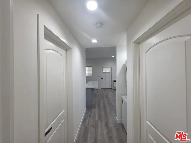 a view of hallway with wooden floor