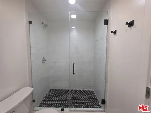 a white toilet sitting next to a bathroom sink