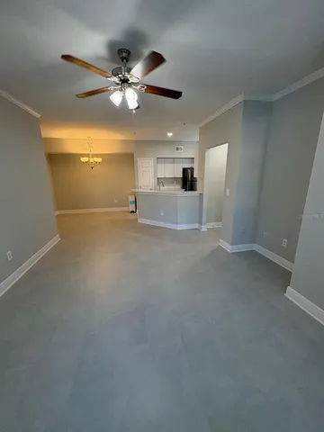 a view of a livingroom with a ceiling fan and window